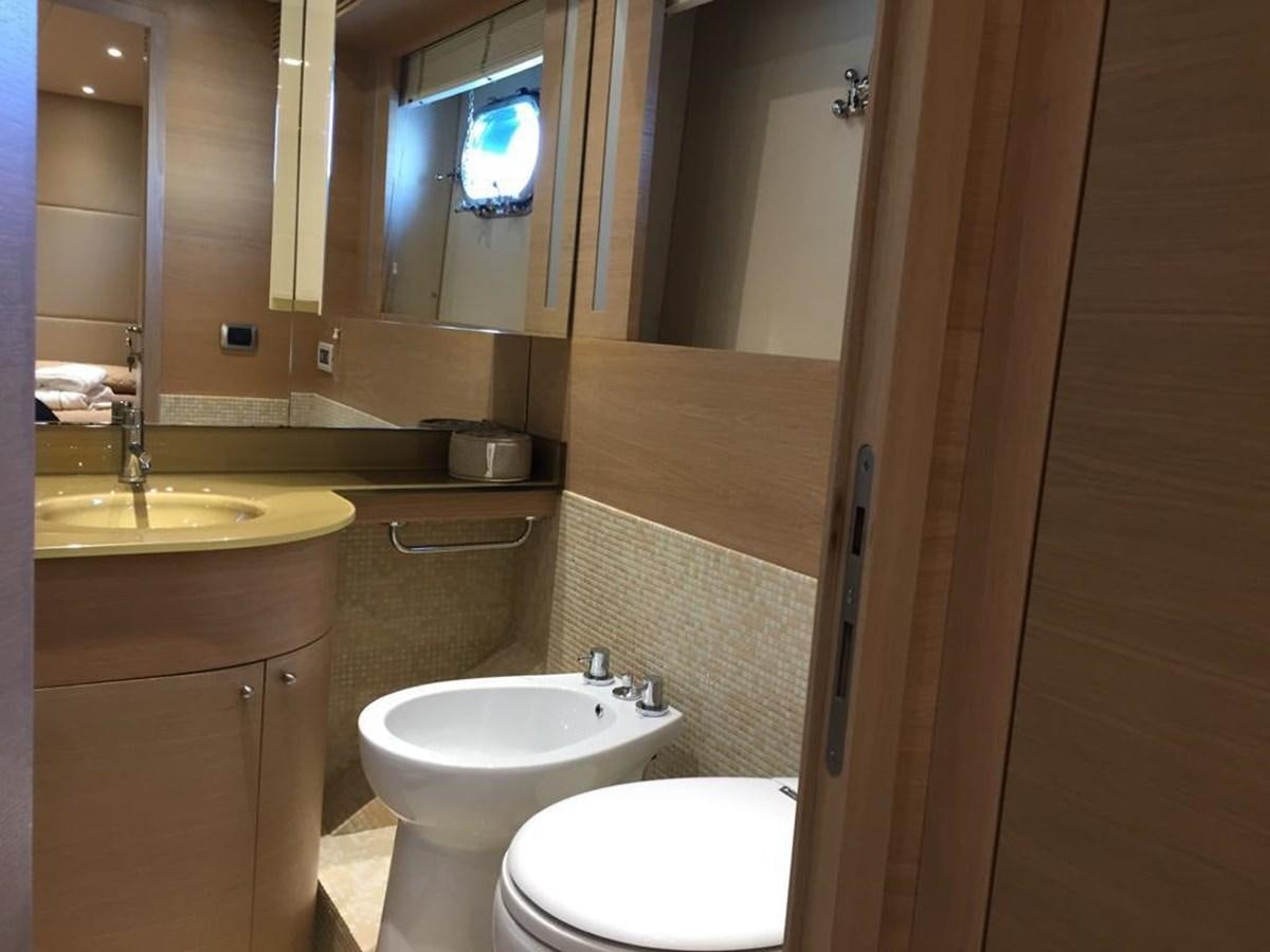 a bathroom with a sink toilet and a mirror aboard PATHOS Yacht for Sale
