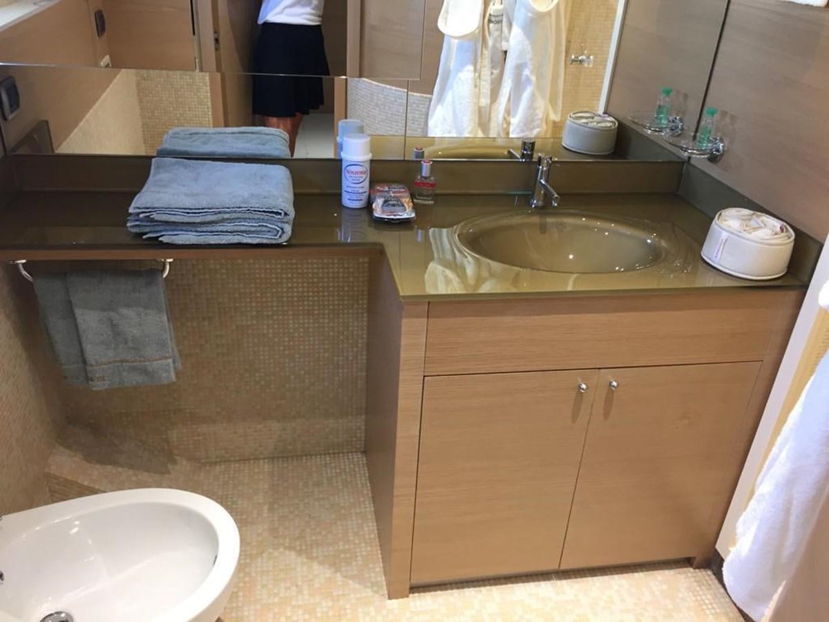 a bathroom with a countertop sink and towels aboard PATHOS Yacht for Sale