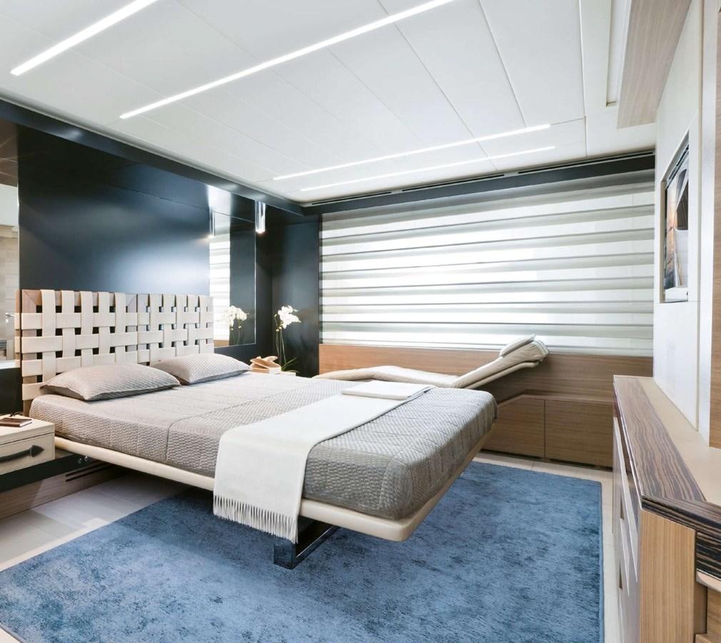 a bedroom with a bed and a window aboard HB Yacht for Sale