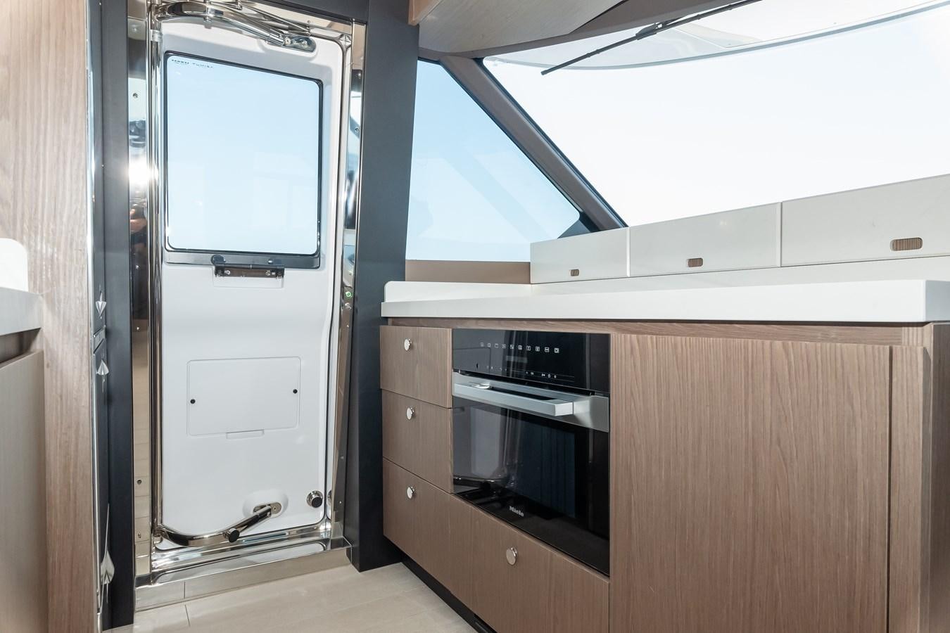 a room with a microwave oven and a refrigerator aboard GREY T Yacht for Sale
