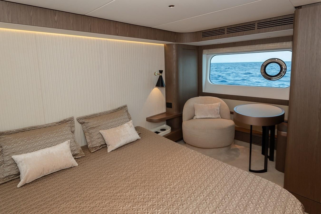 a bed with a large bed and a large window aboard GREY T Yacht for Sale