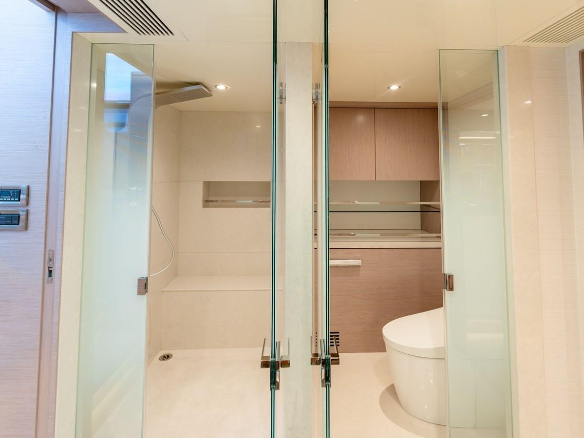 a bathroom with a glass shower aboard OCEAN ALEXANDER 32L11 Yacht for Sale