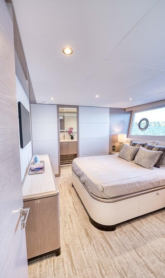 a bedroom with a bed and a desk aboard OCEAN ALEXANDER 32L11 Yacht for Sale