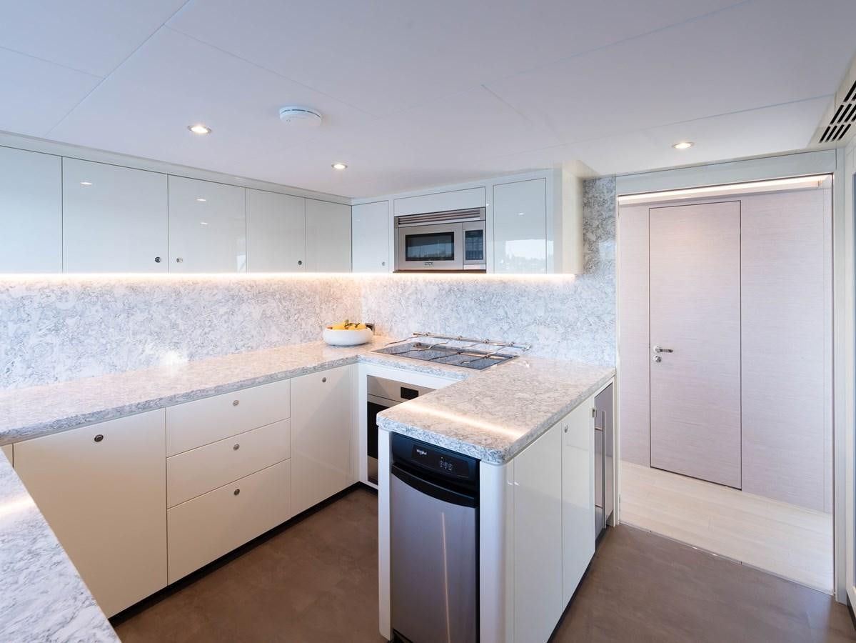 a kitchen with white cabinets aboard OCEAN ALEXANDER 32L11 Yacht for Sale