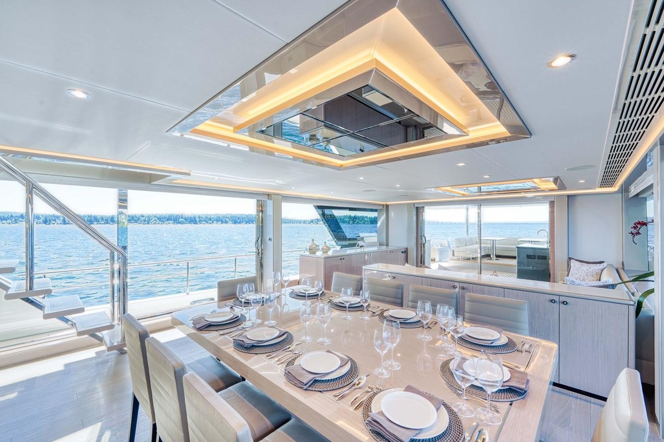 a dining table with plates and chairs aboard OCEAN ALEXANDER 32L11 Yacht for Sale