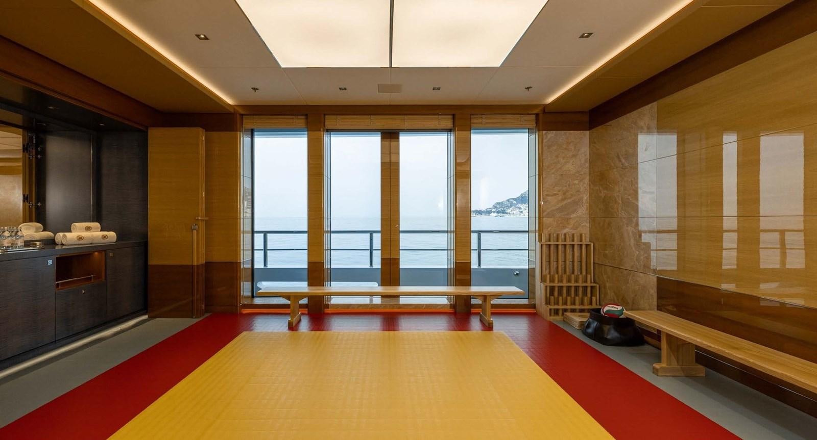 a room with a red carpet and a large window aboard ENERGY Yacht for Sale