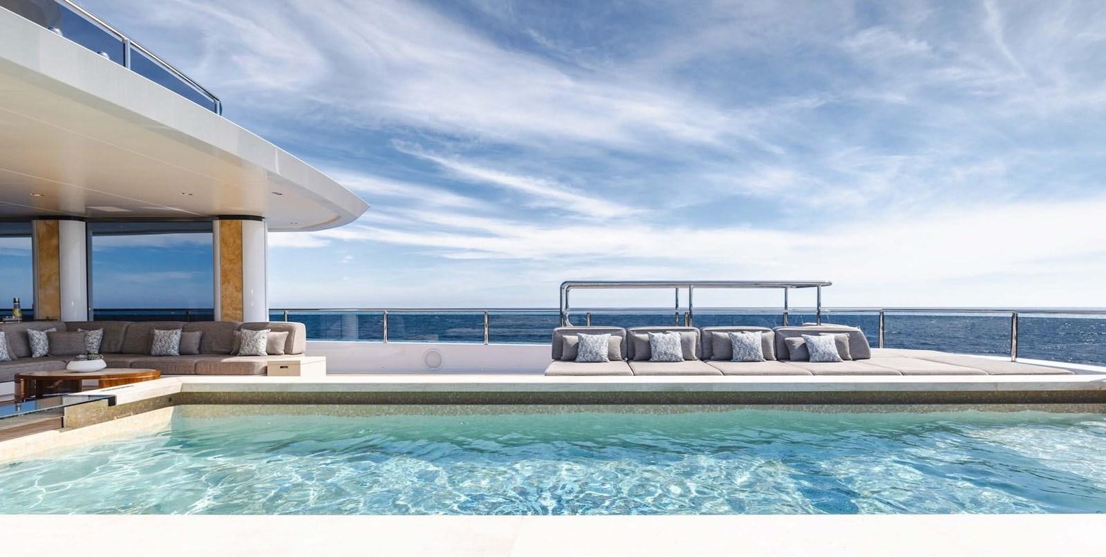 a swimming pool with a large building in the background aboard ENERGY Yacht for Sale