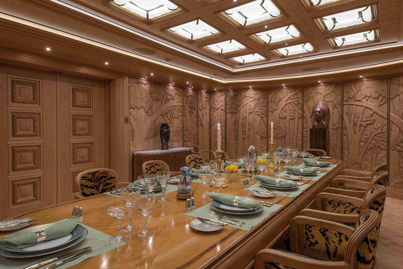 a large room with a table set aboard AURORA Yacht for Sale