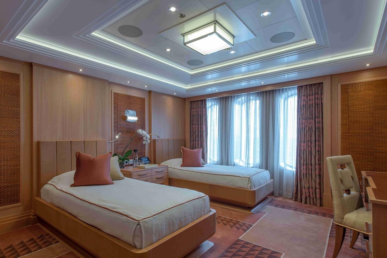 a room with a bed and a chair aboard AURORA Yacht for Sale