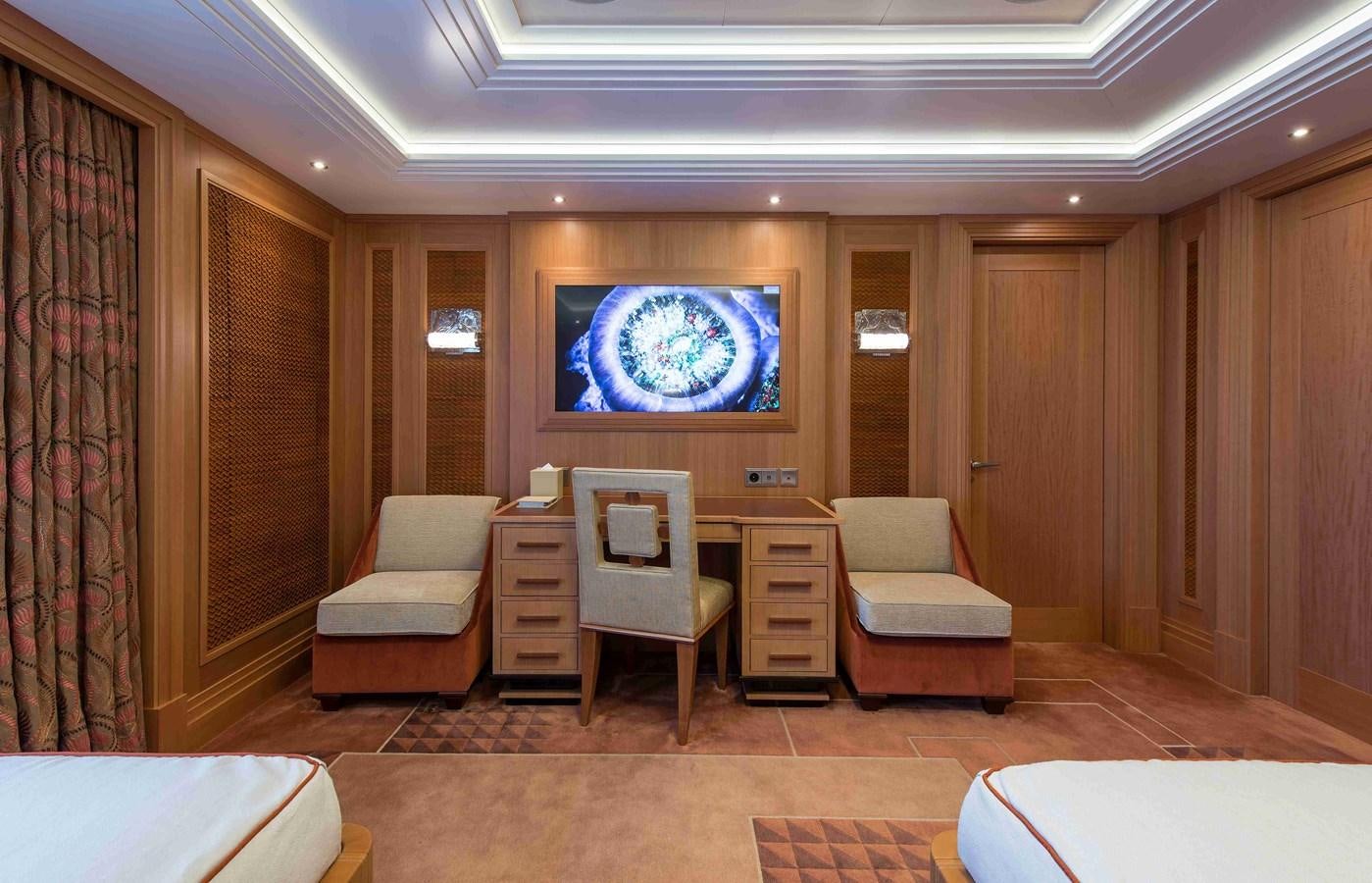 a room with a tv and chairs aboard AURORA Yacht for Sale