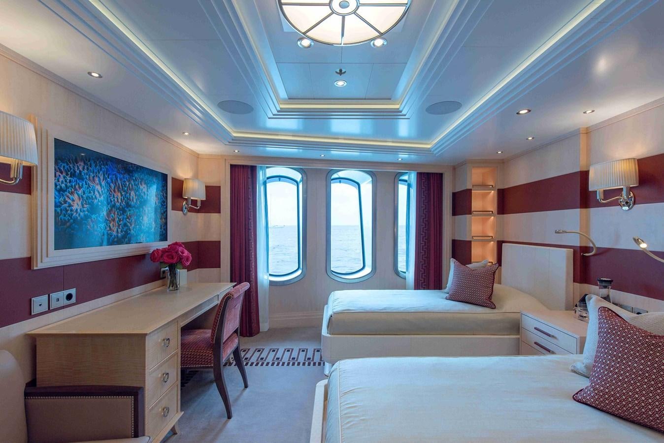 a room with a bed and a desk aboard AURORA Yacht for Sale