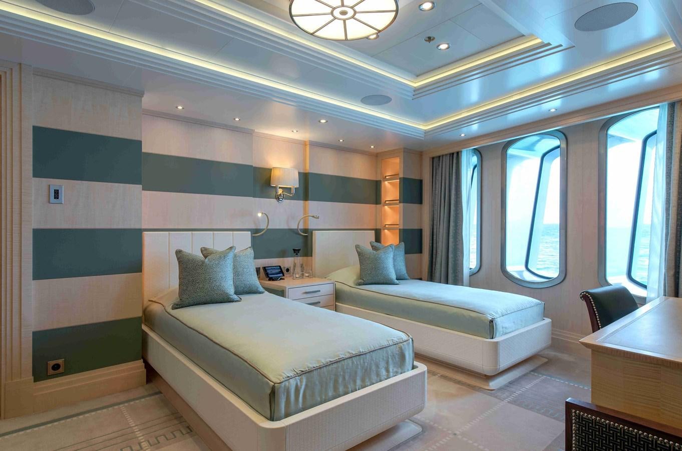 a room with a bed and a desk aboard AURORA Yacht for Sale