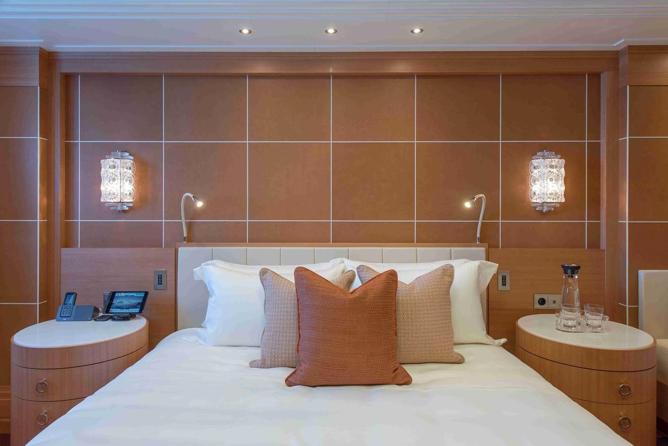 a bed with white sheets and pillows aboard AURORA Yacht for Sale