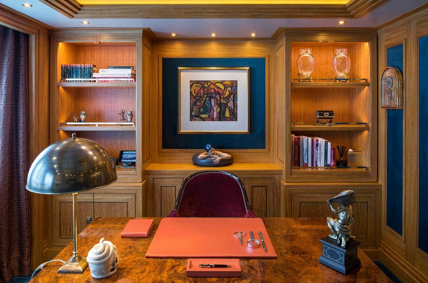 a room with a desk and a lamp aboard AURORA Yacht for Sale