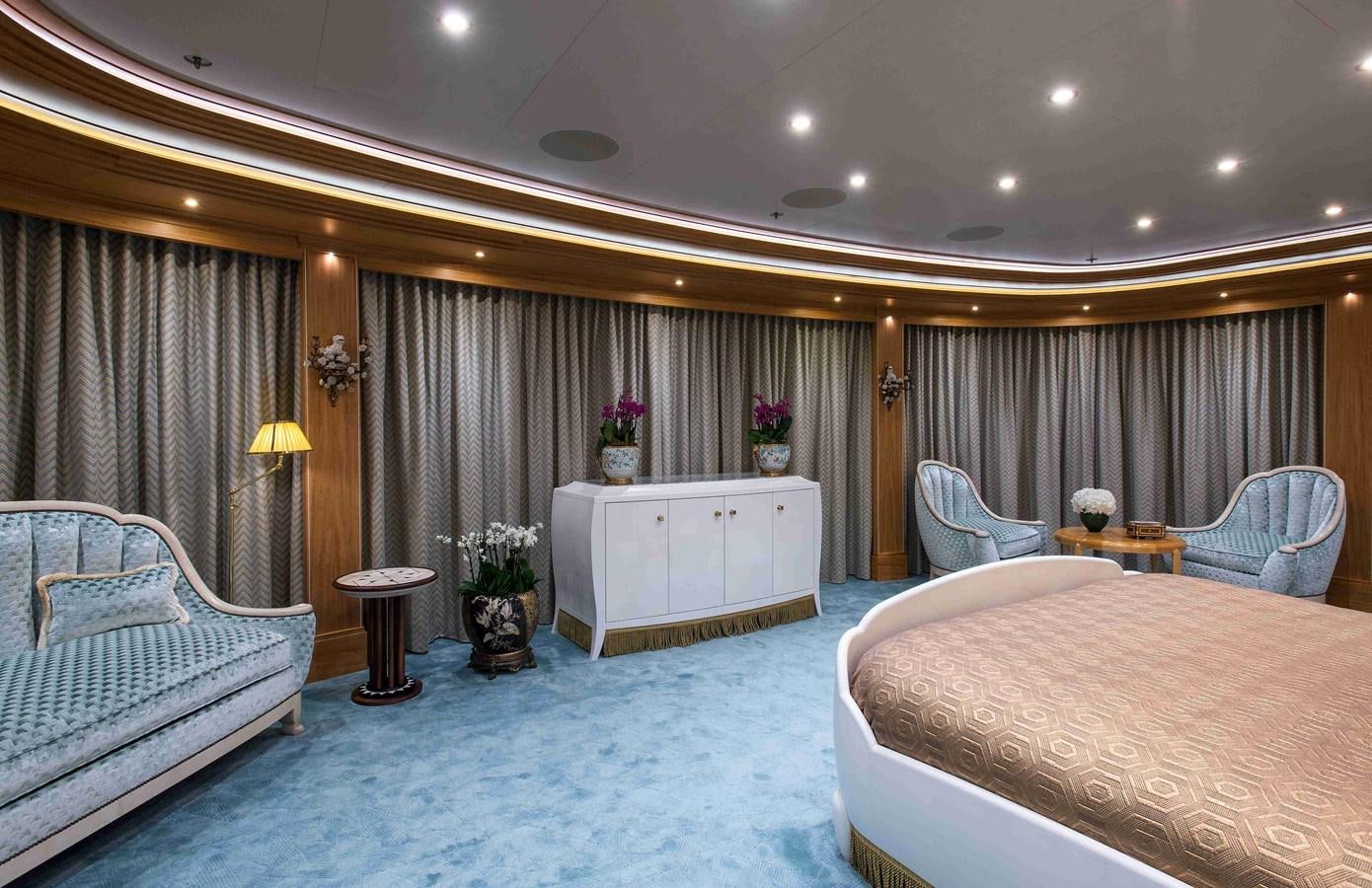 a bedroom with a bed and a chair aboard AURORA Yacht for Sale