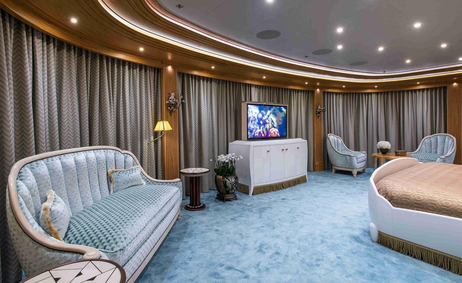 a room with a bed and a chair aboard AURORA Yacht for Sale