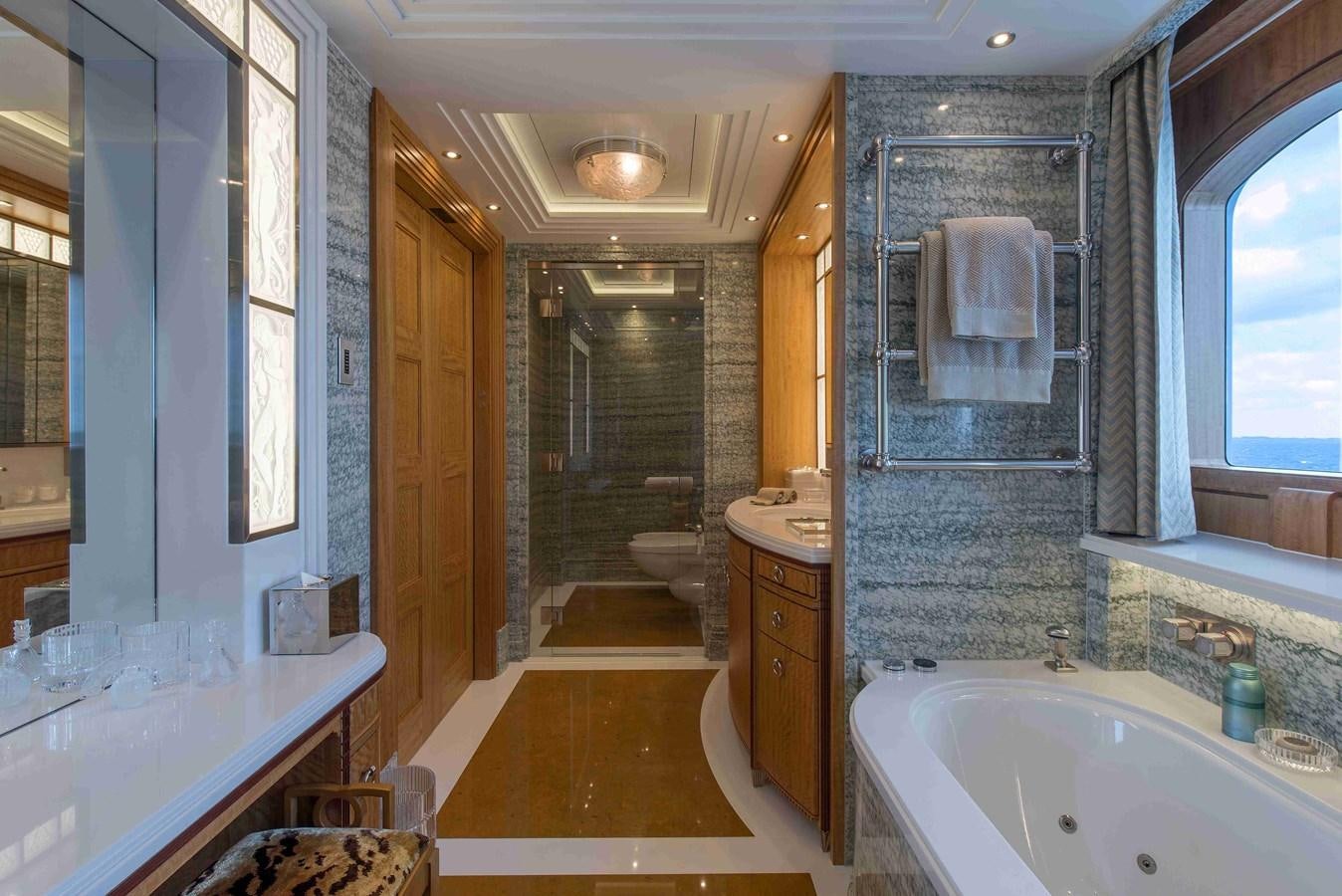 a bathroom with a tub sink and a mirror aboard AURORA Yacht for Sale