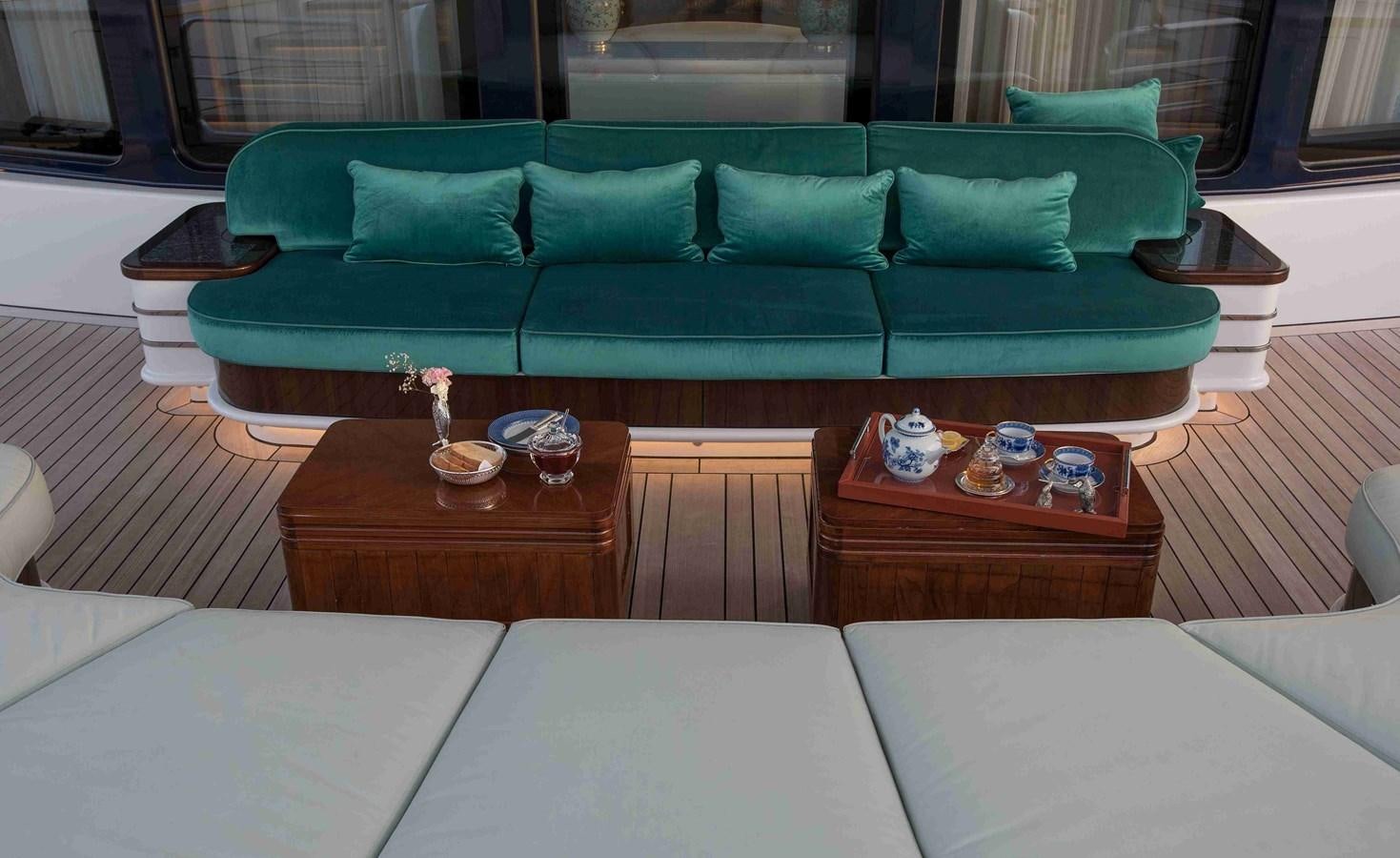 a couch with a coffee table aboard AURORA Yacht for Sale