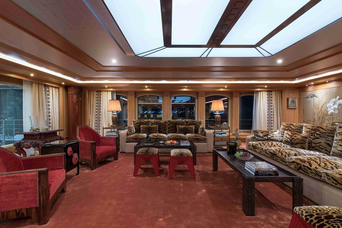 a living room with a large red rug and a large window aboard AURORA Yacht for Sale