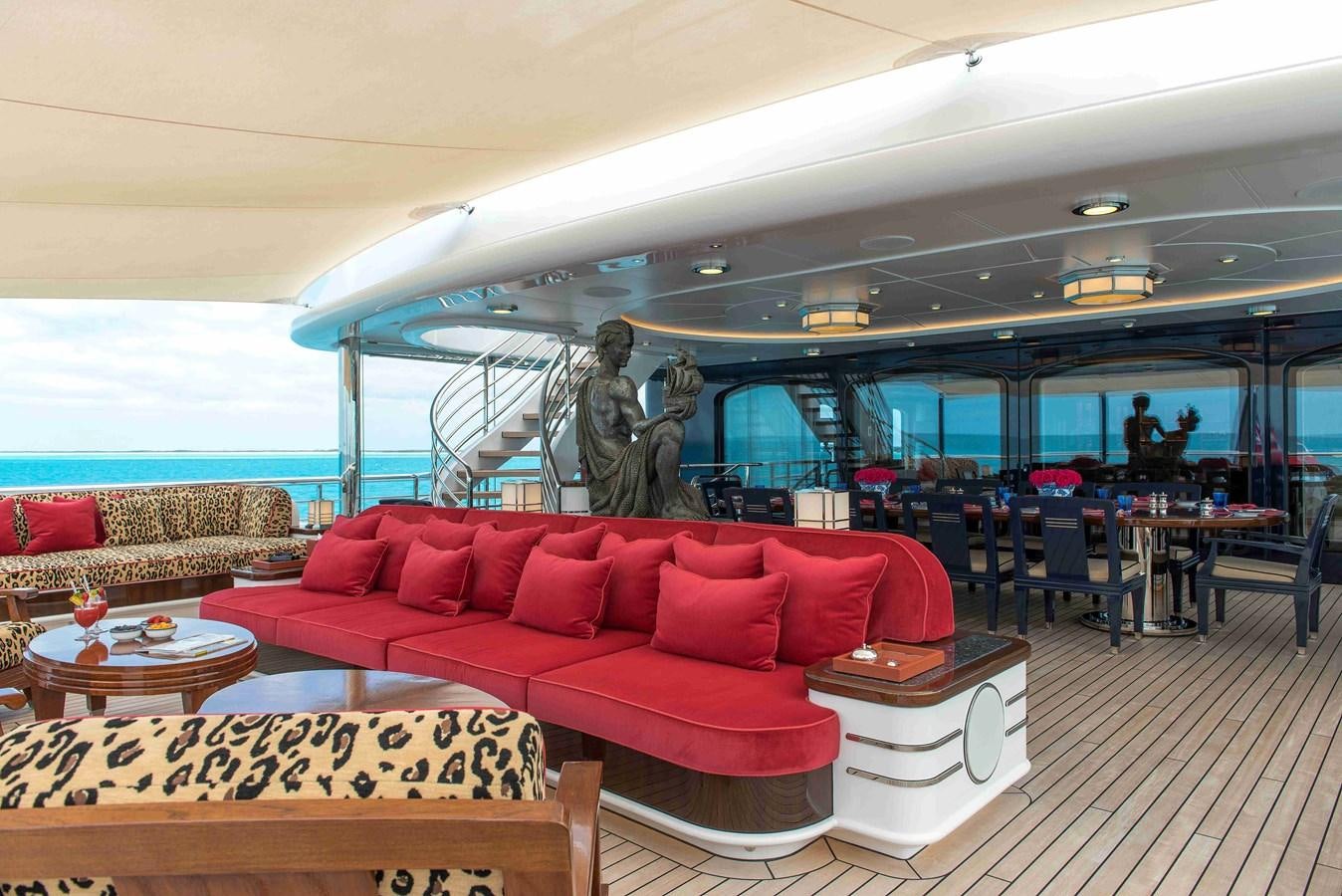 a large room with a couch and a table and chairs aboard AURORA Yacht for Sale