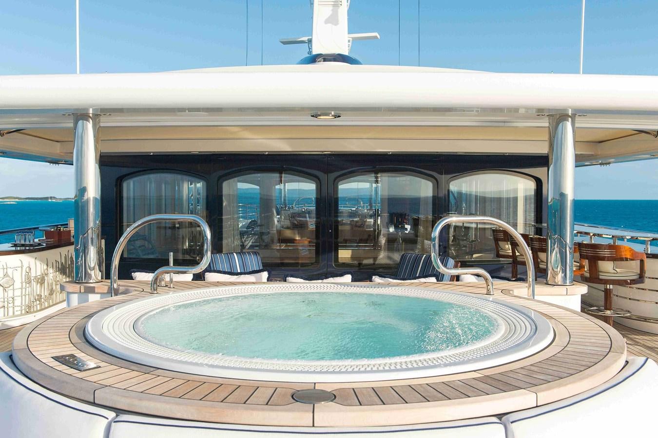 a swimming pool outside a building aboard AURORA Yacht for Sale