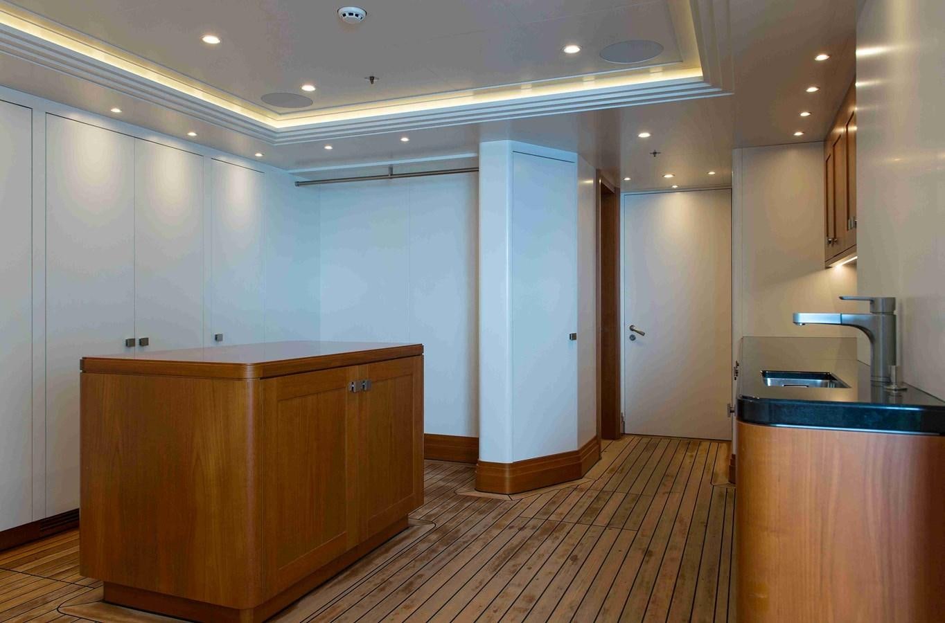 a kitchen with a wood counter and cabinets aboard AURORA Yacht for Sale