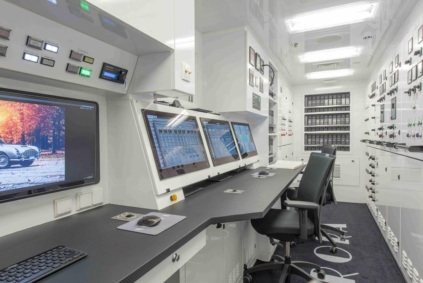 a room with computers and monitors aboard AURORA Yacht for Sale