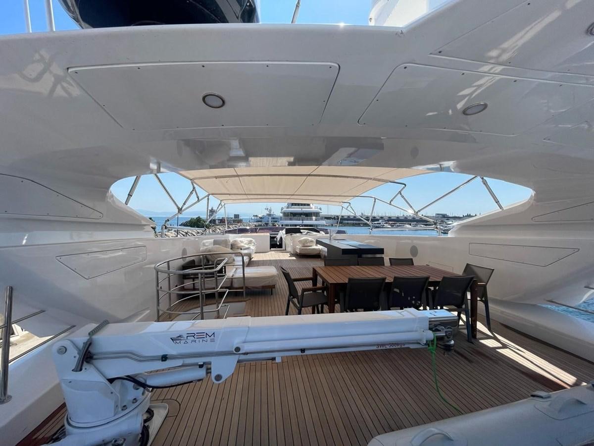 a large airplane with a row of seats and a table in the middle aboard BLUEY Yacht for Sale