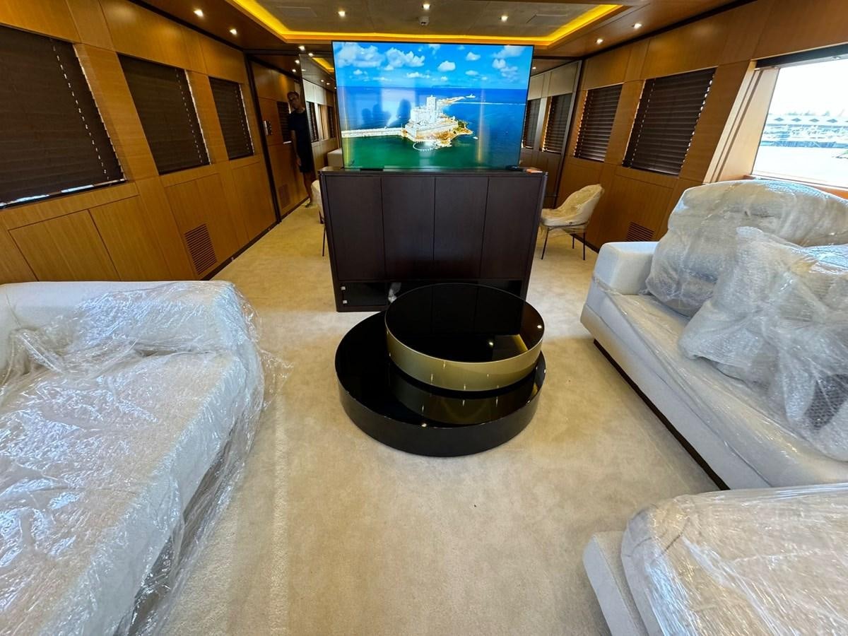 a living room with a tv and couches aboard BLUEY Yacht for Sale
