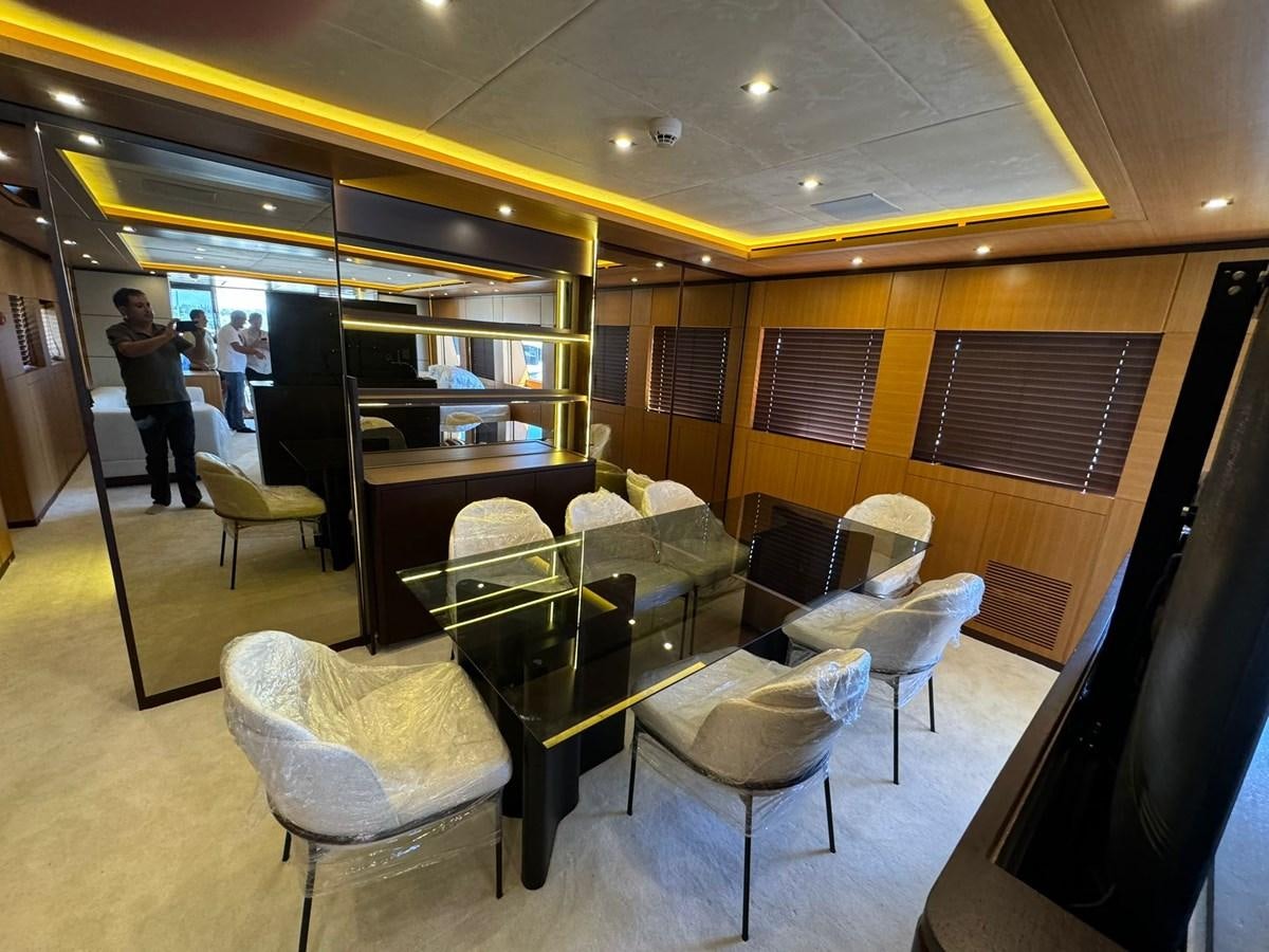 a room with chairs and tables aboard BLUEY Yacht for Sale
