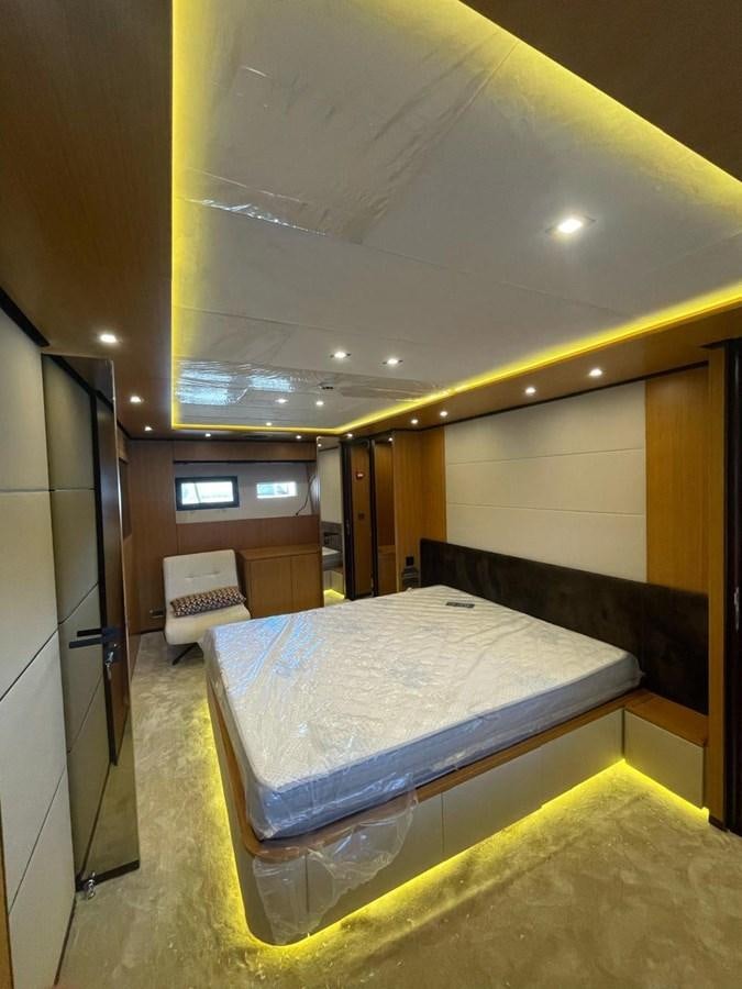a room with a bed and a mirror aboard BLUEY Yacht for Sale