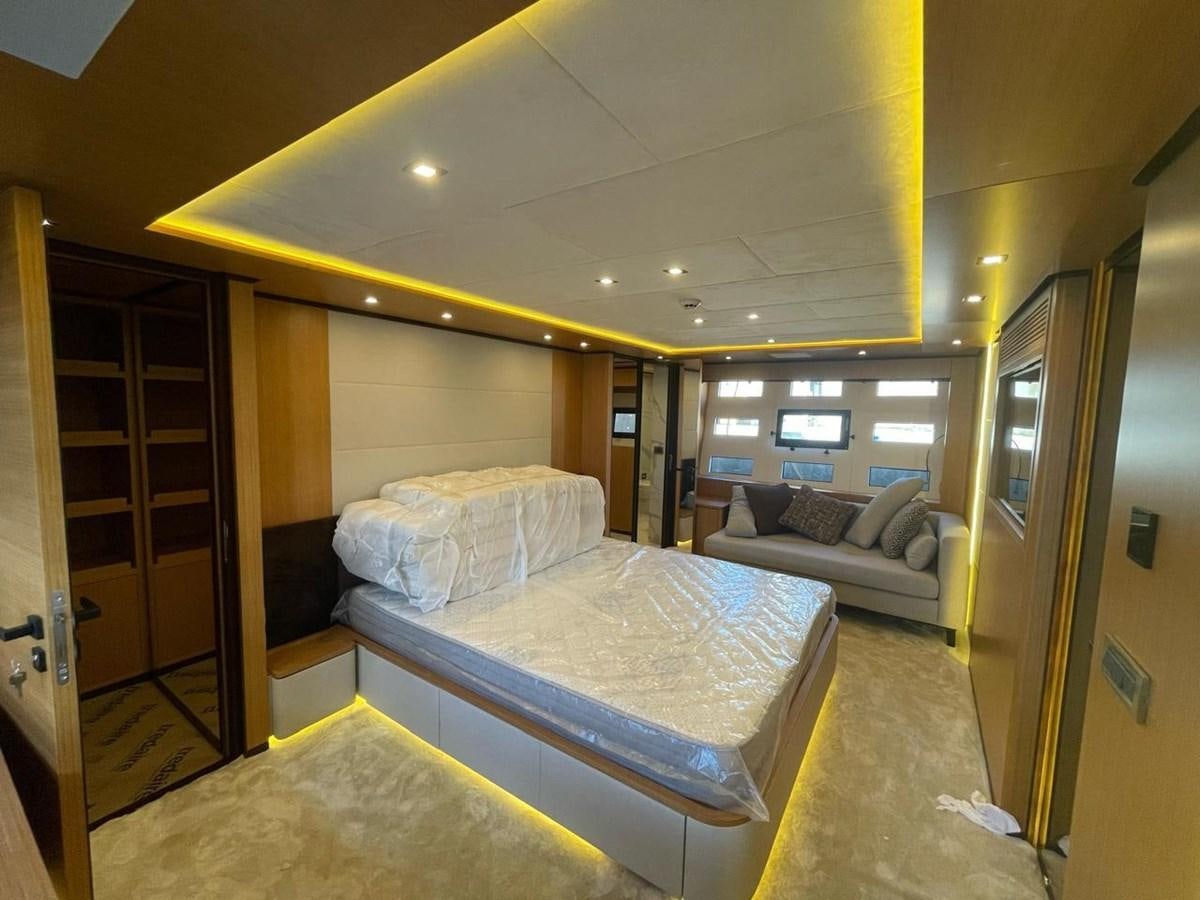 a room with a bed and a couch aboard BLUEY Yacht for Sale