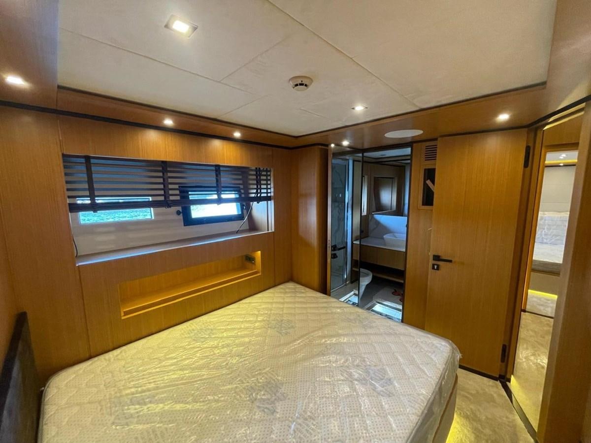 a room with a bed and a closet aboard BLUEY Yacht for Sale