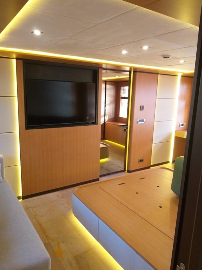 a room with a tv and a table aboard BLUEY Yacht for Sale