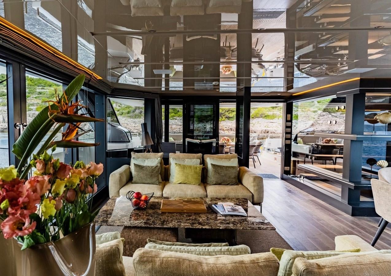 a living room with a large glass window aboard ASYMMETRIC Yacht for Sale