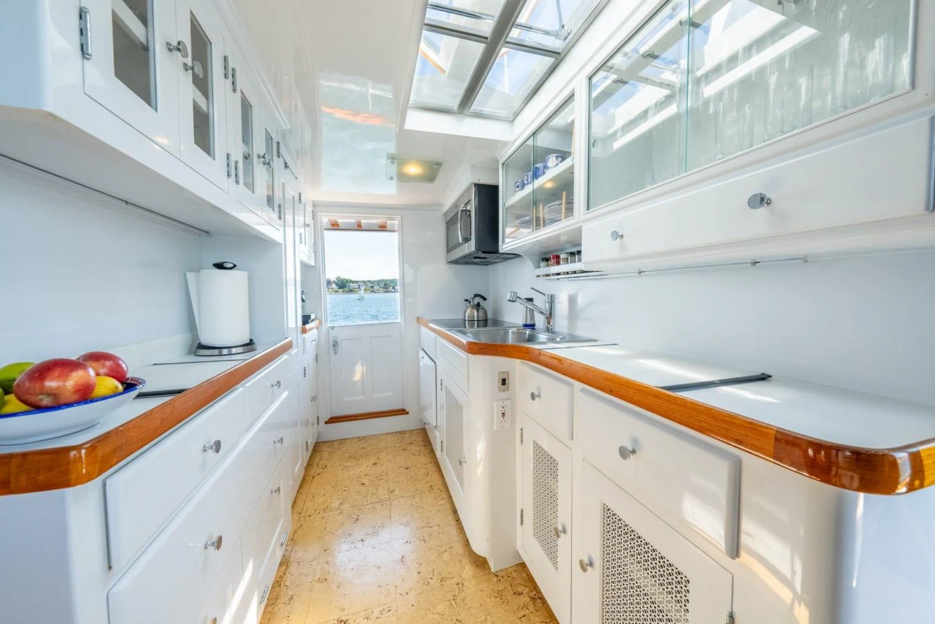 a kitchen with white cabinets aboard BERNADETTE Yacht for Sale
