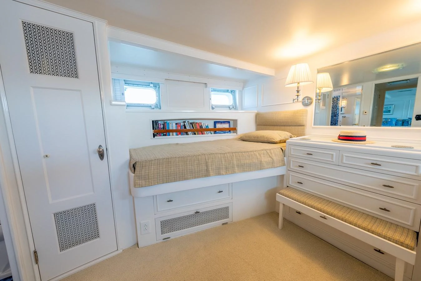 a bedroom with a bed and a desk aboard BERNADETTE Yacht for Sale