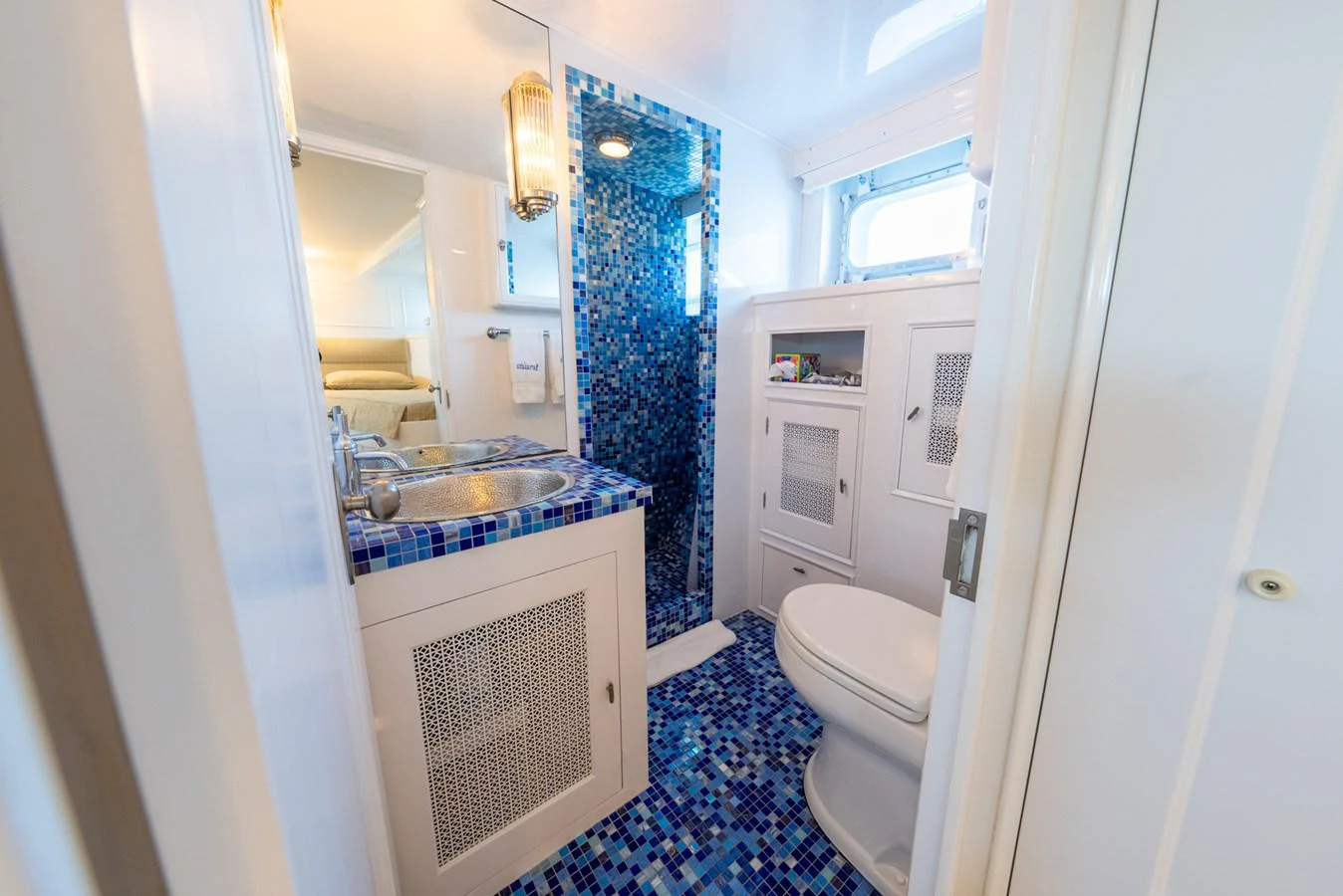 a bathroom with a sink toilet and a mirror aboard BERNADETTE Yacht for Sale