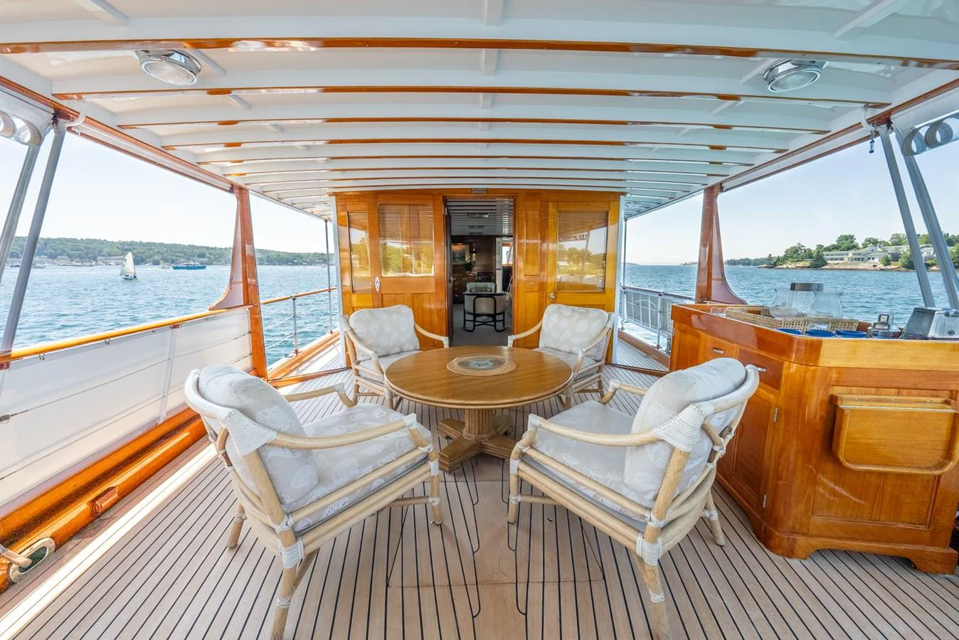 a boat with a table and chairs aboard BERNADETTE Yacht for Sale