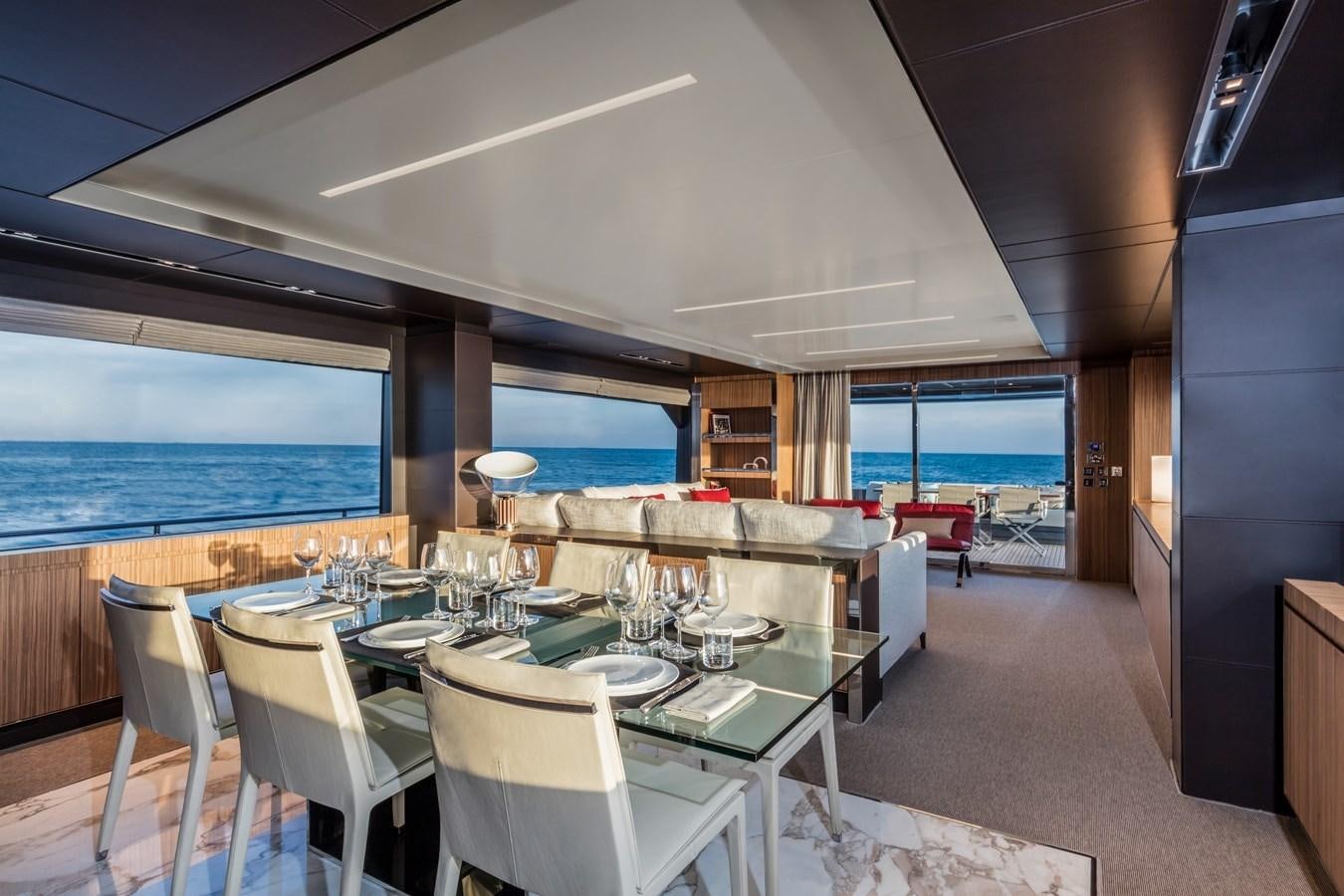 a room with tables and chairs aboard IRON GRYPHON Yacht for Sale