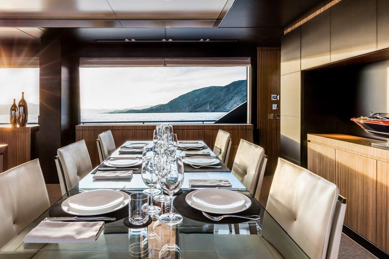 a dining table with plates and silverware aboard IRON GRYPHON Yacht for Sale