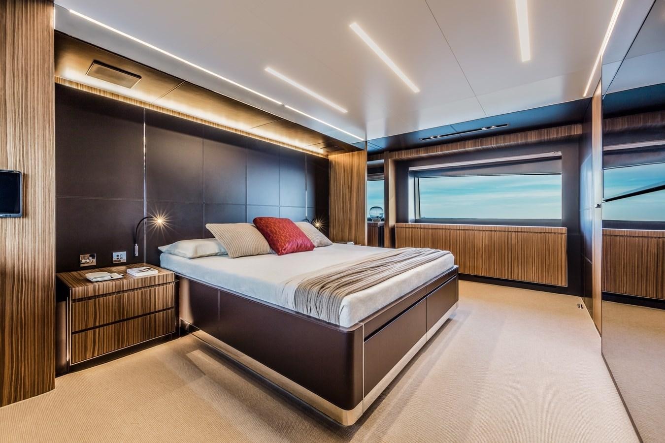 a large bedroom with a large bed aboard IRON GRYPHON Yacht for Sale
