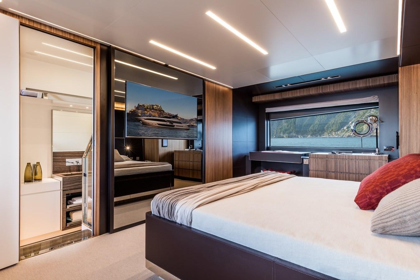 a room with a bed and a television aboard IRON GRYPHON Yacht for Sale