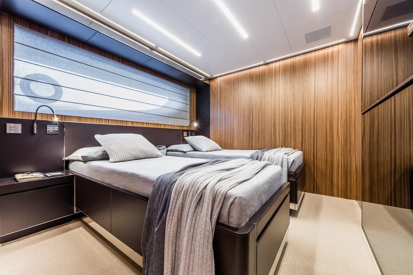 a room with a bed and a window aboard IRON GRYPHON Yacht for Sale