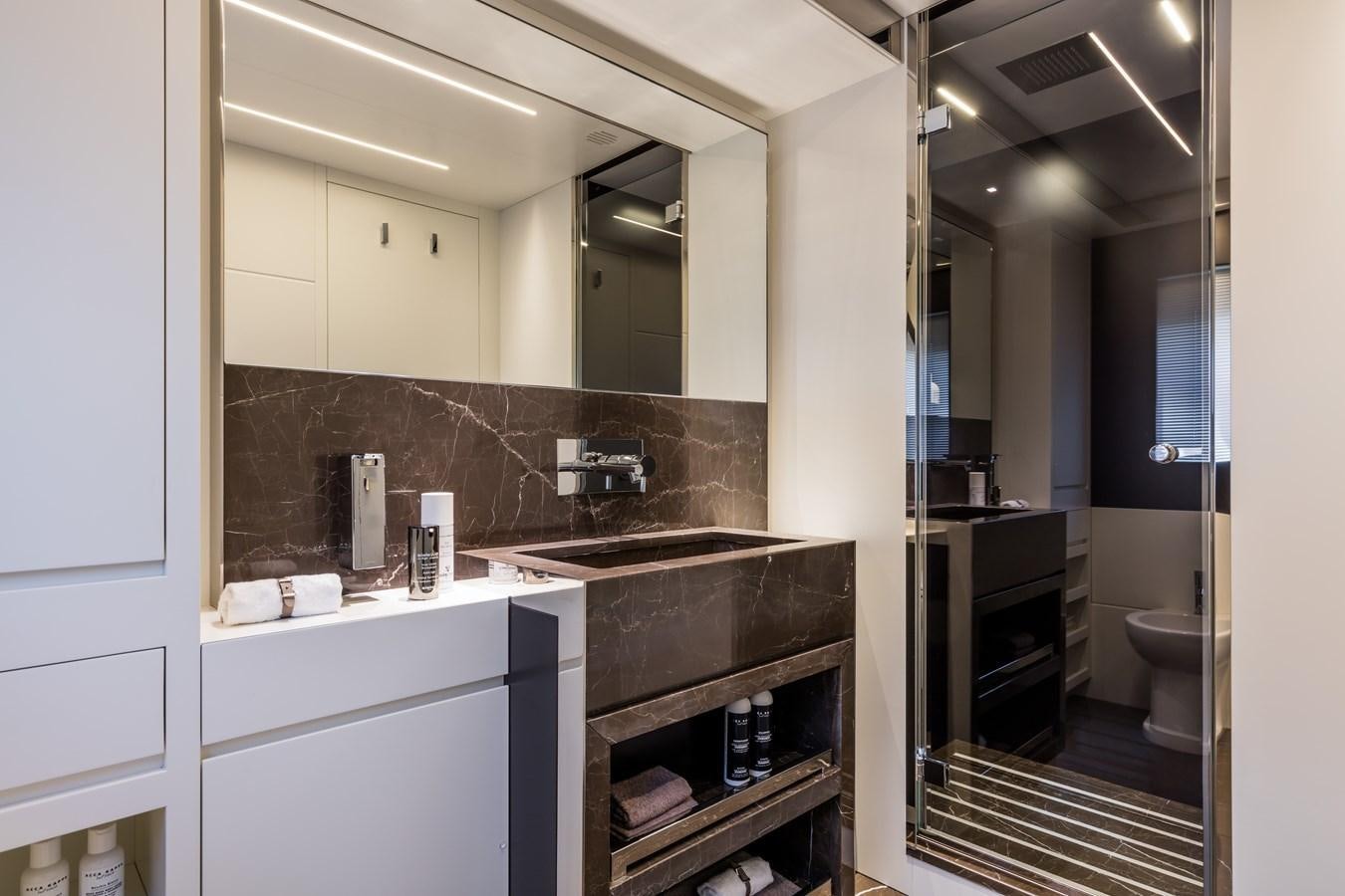 a bathroom with a large mirror aboard IRON GRYPHON Yacht for Sale
