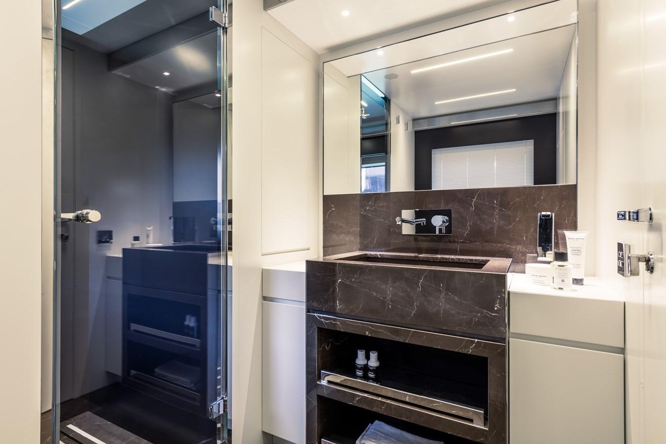 a bathroom with a sink and a mirror aboard IRON GRYPHON Yacht for Sale
