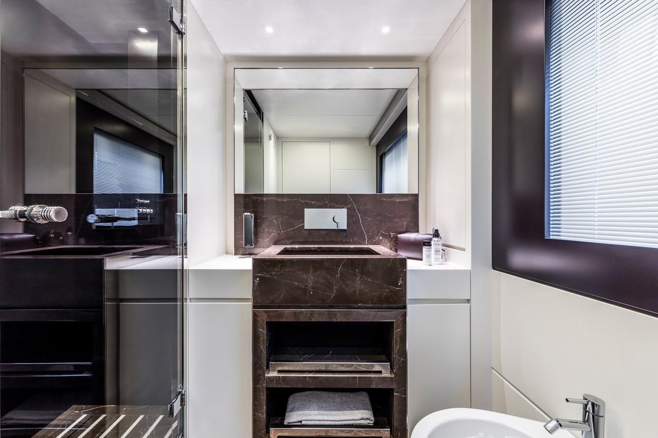 a bathroom with a sink and a mirror aboard IRON GRYPHON Yacht for Sale