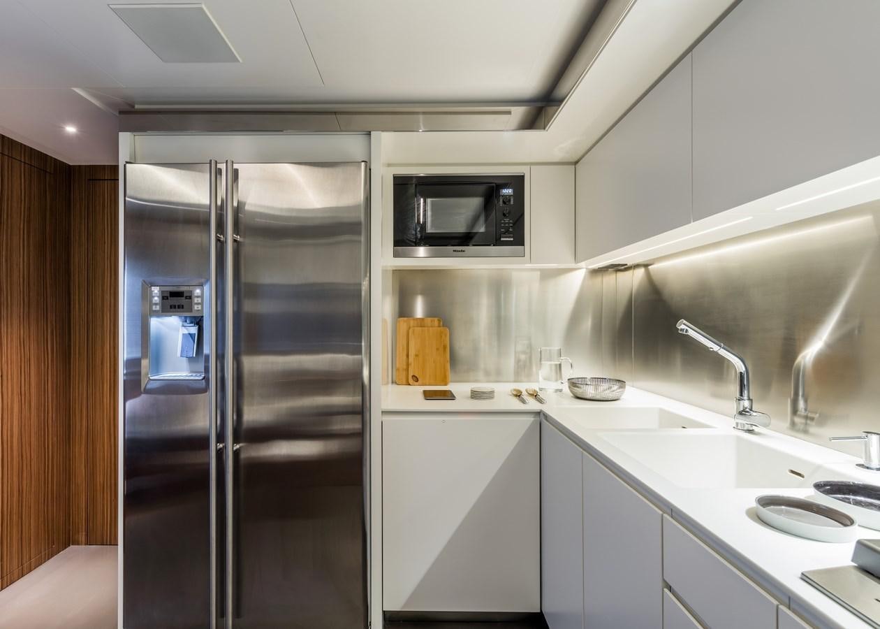a kitchen with a refrigerator and sink aboard IRON GRYPHON Yacht for Sale