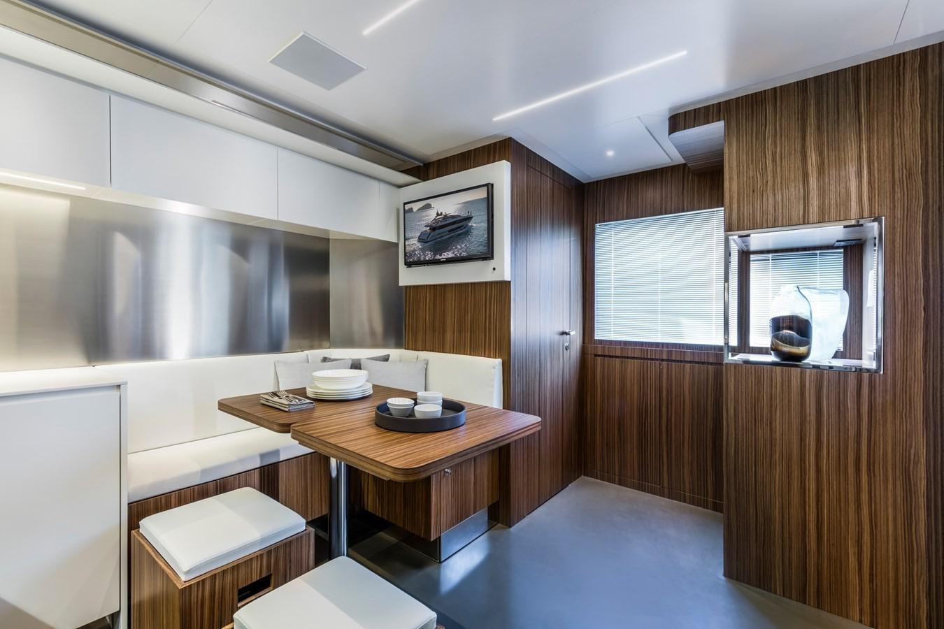 a room with a table and chairs aboard IRON GRYPHON Yacht for Sale