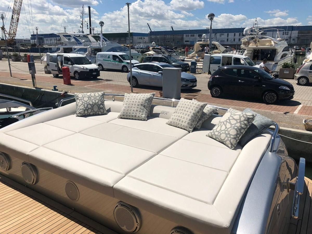 a white couch with pillows aboard QUEEN B SPORT Yacht for Sale